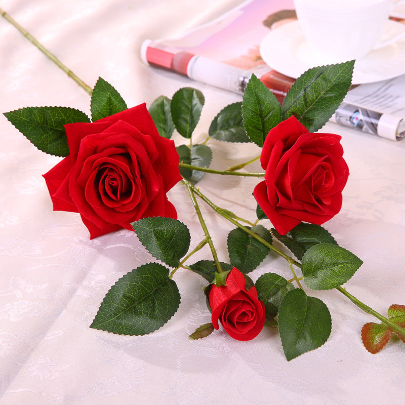 Artificial rose flower in realistic bloom with green leaves