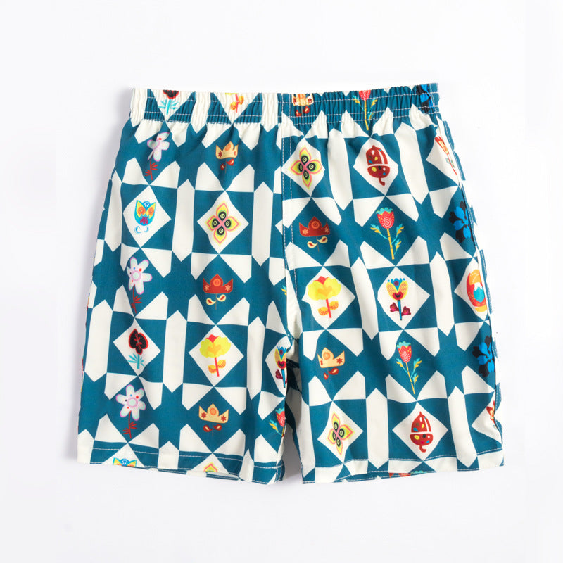 Children's beach shorts boxer swimming trunks in blue and colorful design