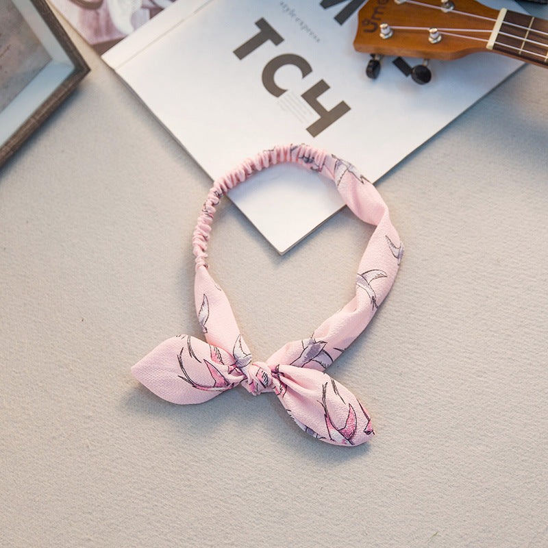 Big bow tie bunny ears headband with soft pink ears and oversized bow detail