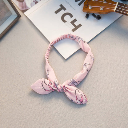 Big bow tie bunny ears headband with soft pink ears and oversized bow detail