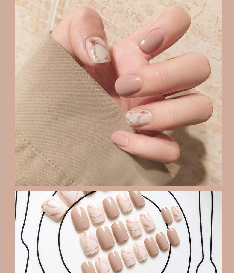 Light khaki smudge false nails in a modern abstract design, displayed as a set of press-on tips
