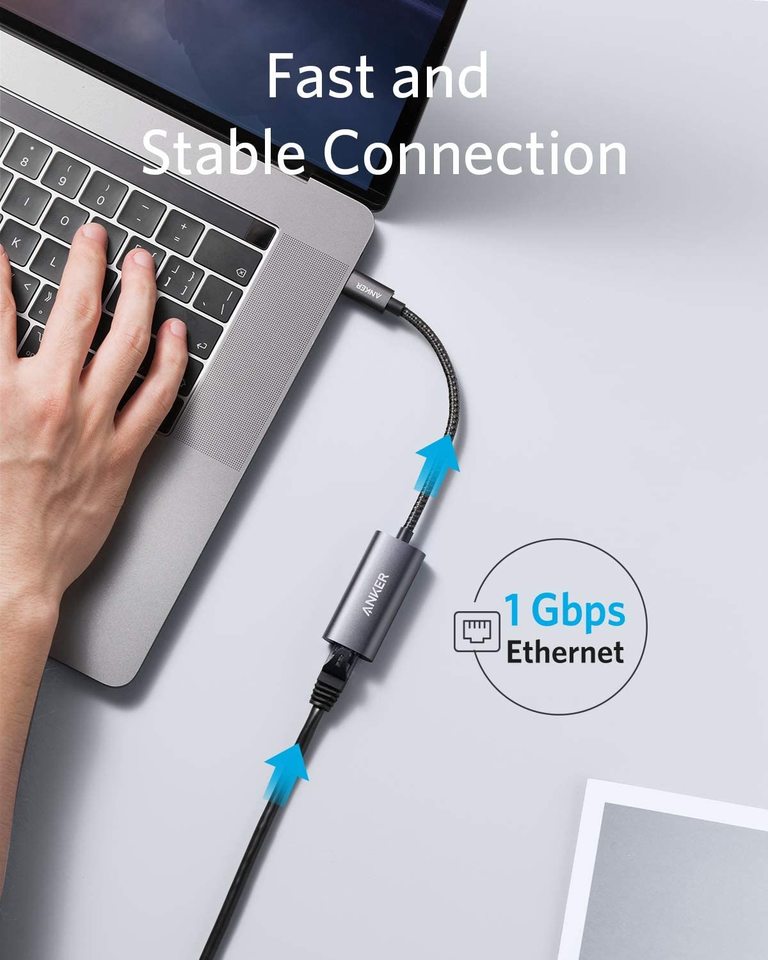 Anker PowerExpand USB-C to Gigabit Ethernet Adapter connected to a laptop, showing the compact design and Ethernet port.
