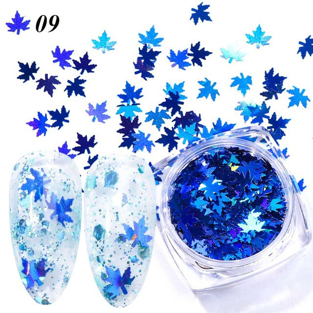 Gradient maple leaf nail sequins in red, orange, and gold tones for nail art