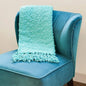 Pool blue microfiber throw blanket with popcorn texture, Victorian style, used on sofa or bed for cozy all-season comfort.