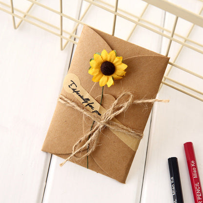 Creative kraft dried flower greeting card with rustic paper design and botanical embellishment