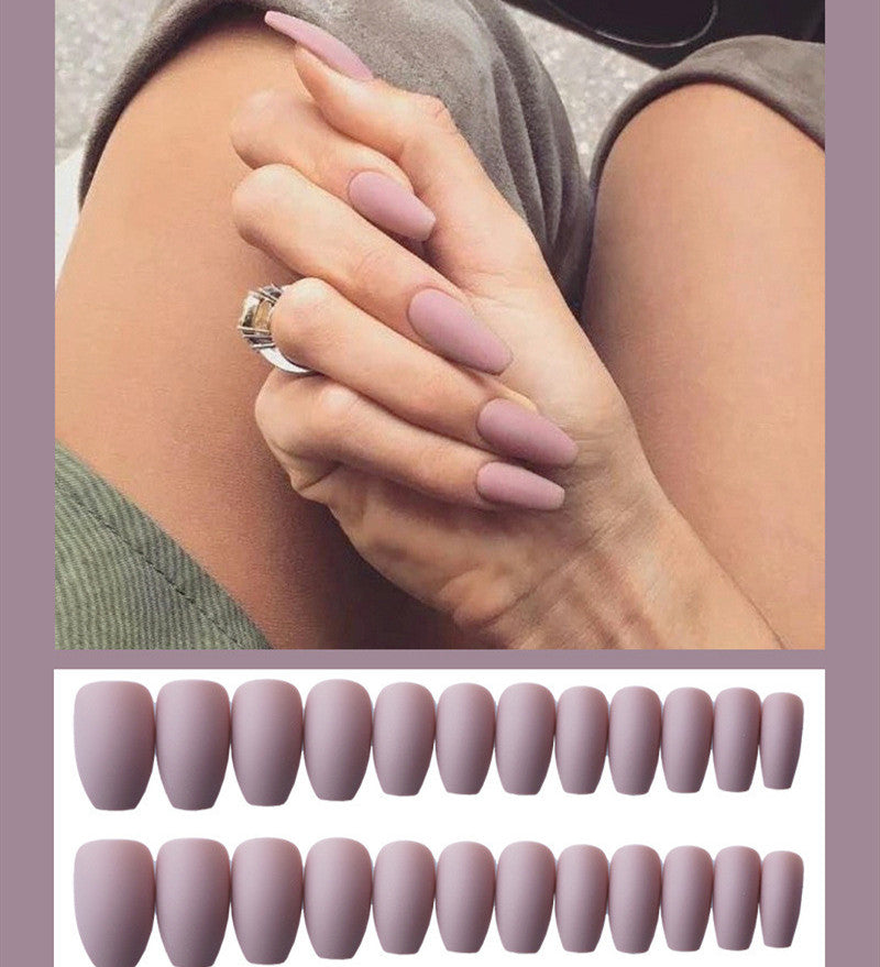 Frosted ballet fake nails in soft pink, almond-shaped design close-up
