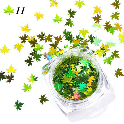 Gradient maple leaf nail sequins in red, orange, and yellow tones for nail art