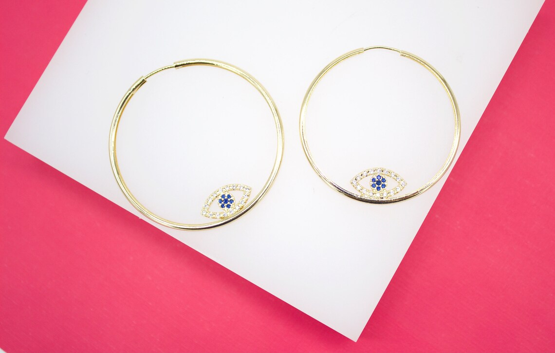 MIA Jewelry Evil Eye endless hoop earrings with micro CZ stones, silver-toned hoops with detailed eye design