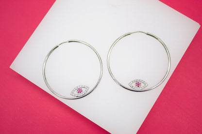 MIA Jewelry evil eye endless hoop earrings with micro CZ stones, silver-tone hoops featuring intricate eye design and sparkling accents.