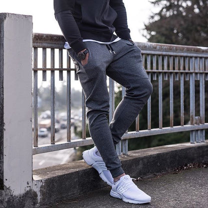 Black running training pants displayed against a plain background