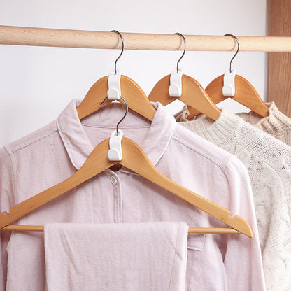 Plastic closet stack hanger rack with multi-function wardrobe hooks for space-saving bedroom storage.