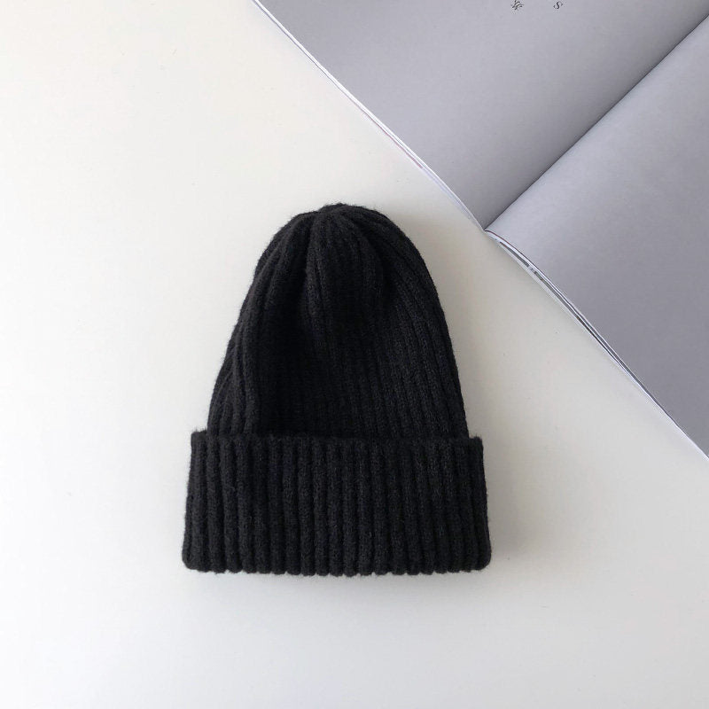 Warm knitted hat in a soft textured design, shown from the front