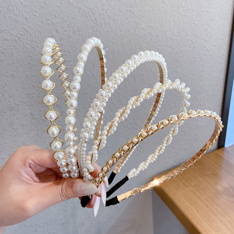 Thin pearl headband with delicate pearl embellishments on a slim band