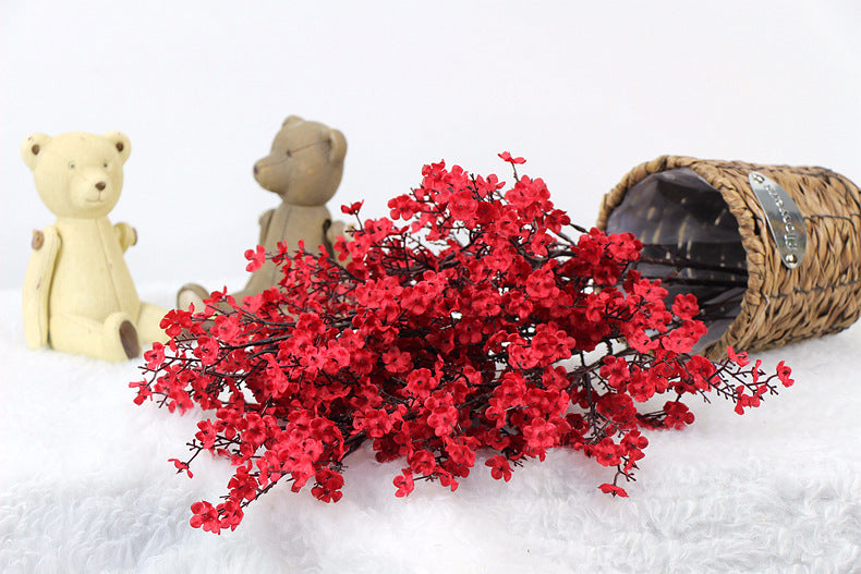 Artificial flower in a natural-looking arrangement with soft petals and green foliage