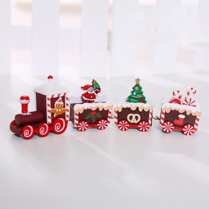 Wooden Christmas train decoration with festive red and green details, displayed as a holiday ornament set