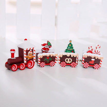 Wooden Christmas train decoration with festive red and green details, displayed as a holiday ornament set