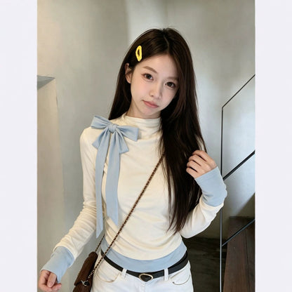 Light blue long-sleeved women’s blouse with a bow detail