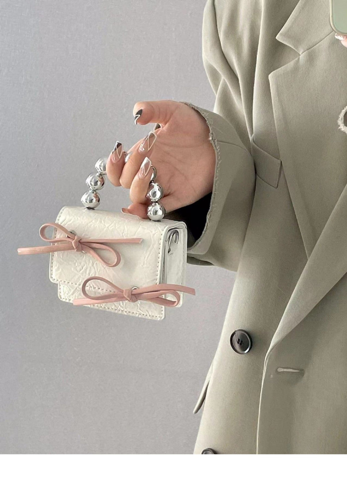Textured cute bow mini chain handbag in a compact design with decorative bow detail and chain strap