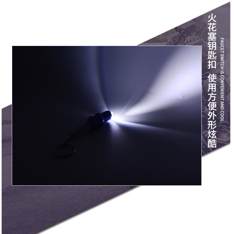 LED light spark plug keychain with metallic finish and compact design