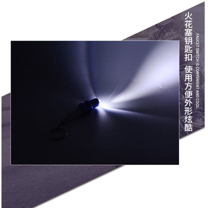 LED light spark plug keychain with metallic finish and compact design