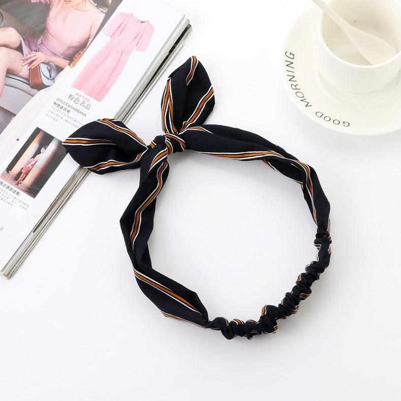 Big bow tie bunny ears headband with soft fabric ears and oversized bow detail
