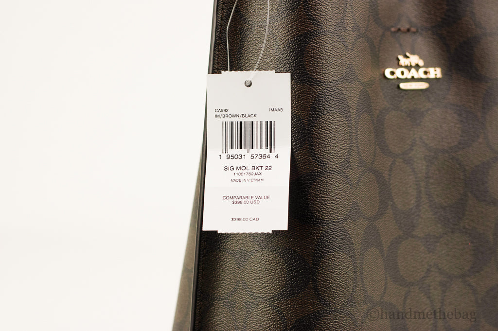Coach Mollie 22 Small Brown and Black coated canvas bucket crossbody handbag with adjustable strap and logo details.