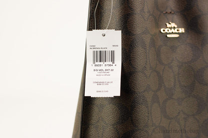 Coach Mollie 22 Small Brown and Black coated canvas bucket crossbody handbag with adjustable strap and logo details.