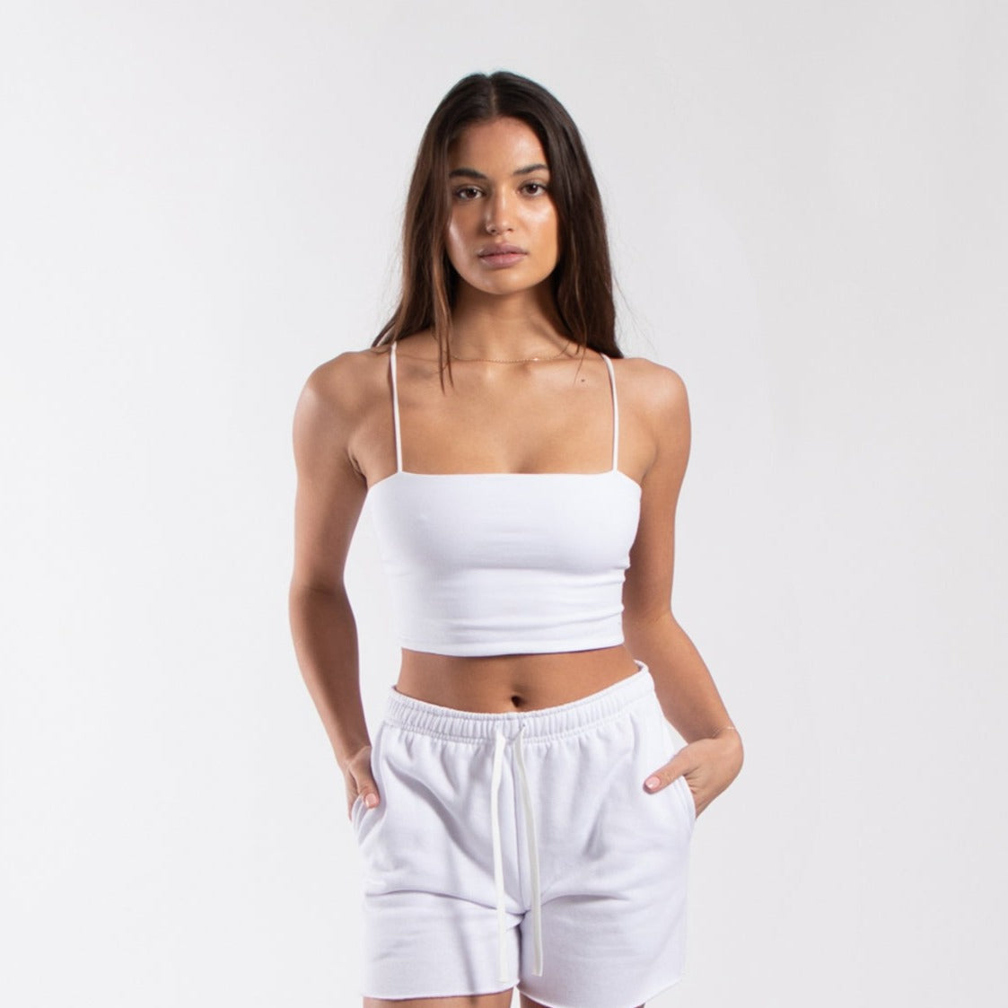 Women's cropped bralette tank top from POS Wholesale, closeout style, with a fitted design and sleeveless cut, in a neutral color.