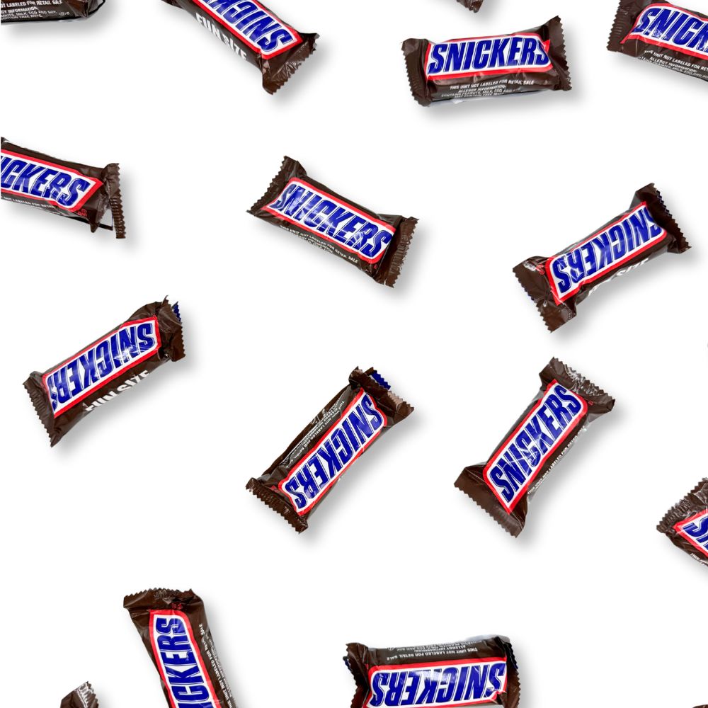 Fun size Snickers chocolate candy bars from Candy In Bulk, shown in a bulk value bag, with chocolate coating and caramel filling.