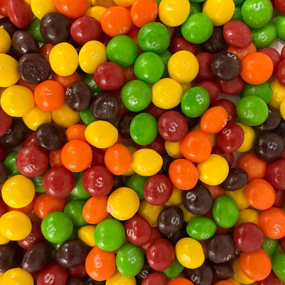 Assorted Skittles Original Fruit Candy in a bulk value bag from Candy In Bulk, showing colorful candies with vibrant fruit flavors.