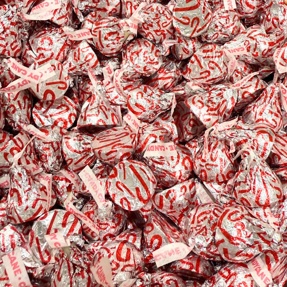 Hershey’s Kisses Candy Cane Mint chocolates with striped coating and candy bits, shown in a bulk value bag from Candy In Bulk.