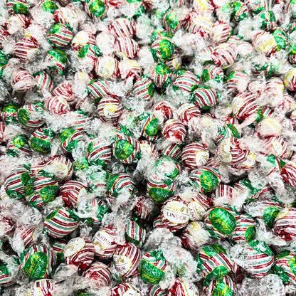 Assorted Lindt LINDOR peppermint chocolate truffles in a bulk Candy In Bulk bag, showcasing smooth chocolate shells with peppermint filling.