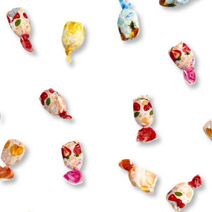 Assorted fruit-filled hard candies from Candy In Bulk in a clear bowl, showcasing colorful and shiny candy pieces.
