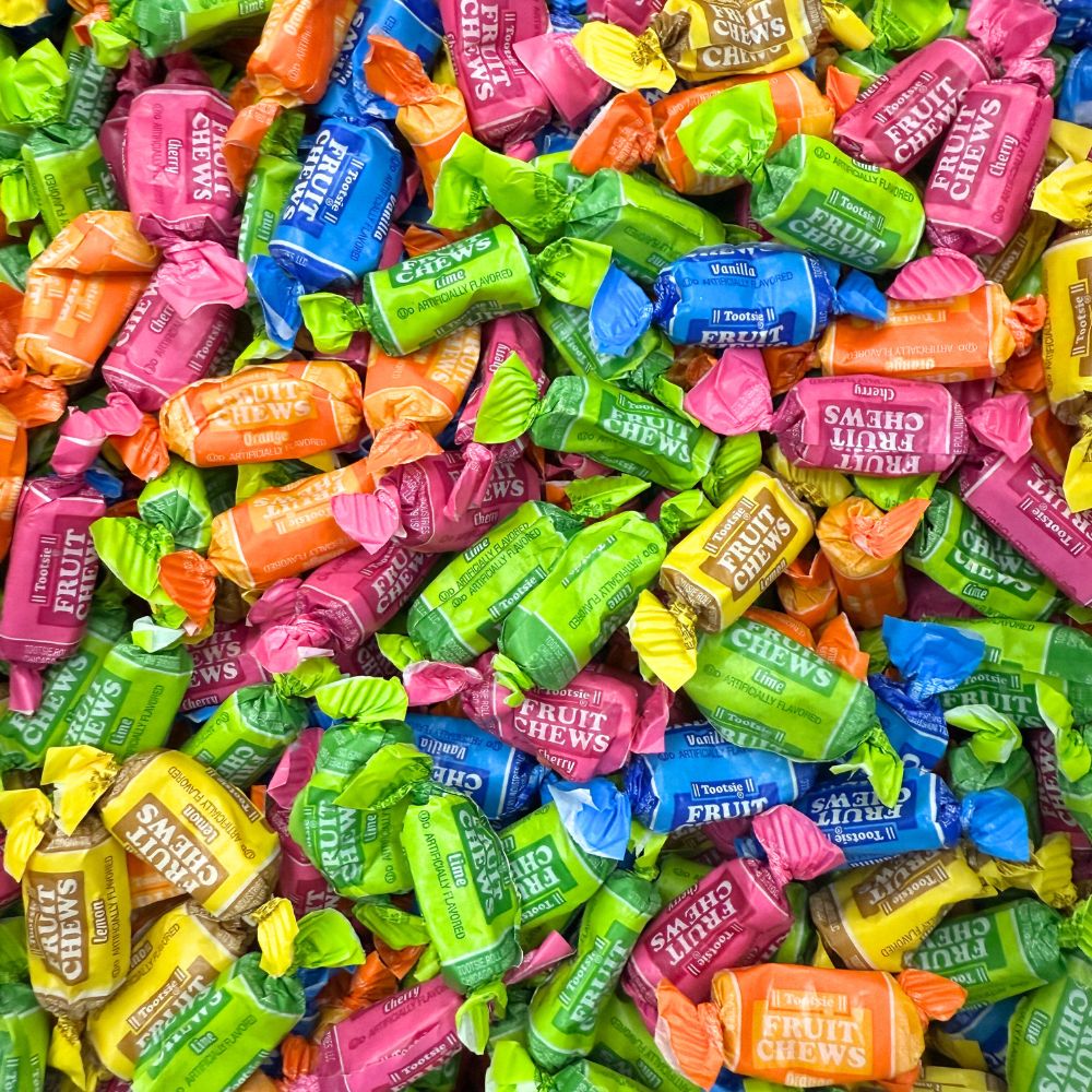 Assorted Tootsie Roll Fruit Chews by Candy In Bulk in a colorful bulk candy bag with various fruity flavors visible.