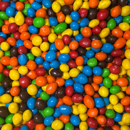 Assorted M&M's Peanut Milk Chocolate Candy in bulk bag, featuring colorful coated chocolate candies from Candy In Bulk.