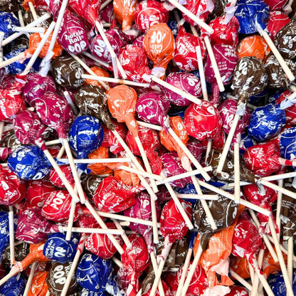 Assorted flavor Tootsie Roll Pops lollipops from Candy In Bulk in a clear bag, showing colorful round candies on sticks.