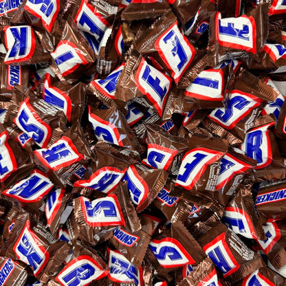 Mini Snickers chocolate candy bars from Candy In Bulk in a bulk value bag, showing individually wrapped bite-sized chocolate bars.