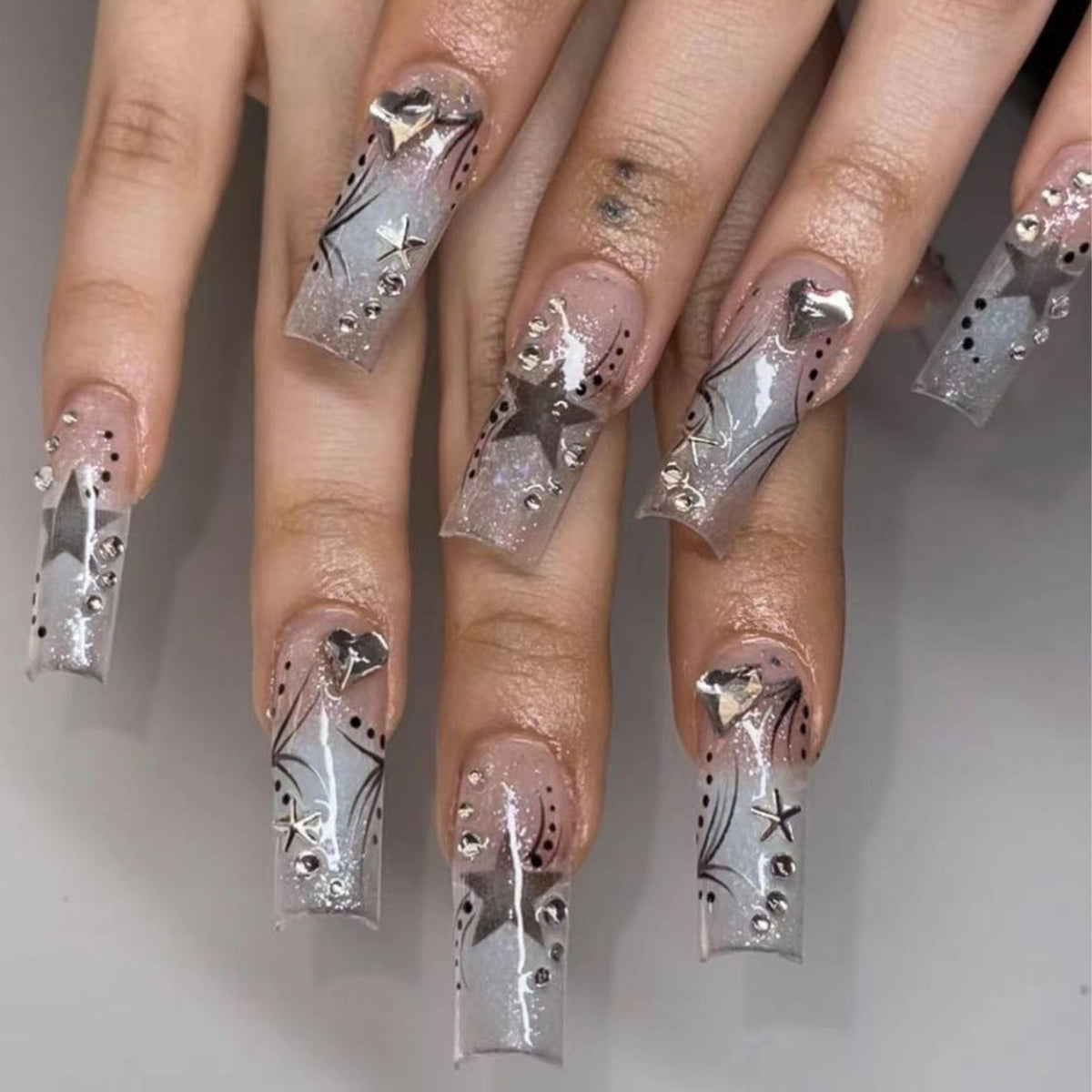 Women's fashion rhinestone patch nails in assorted decorative designs, close-up product view