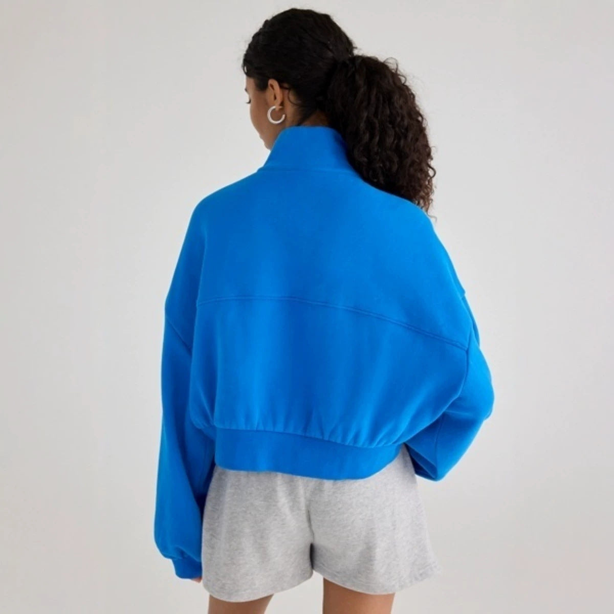 Women's half-zip lapel sweatshirt with loose fit, puff sleeves, and short pullover design