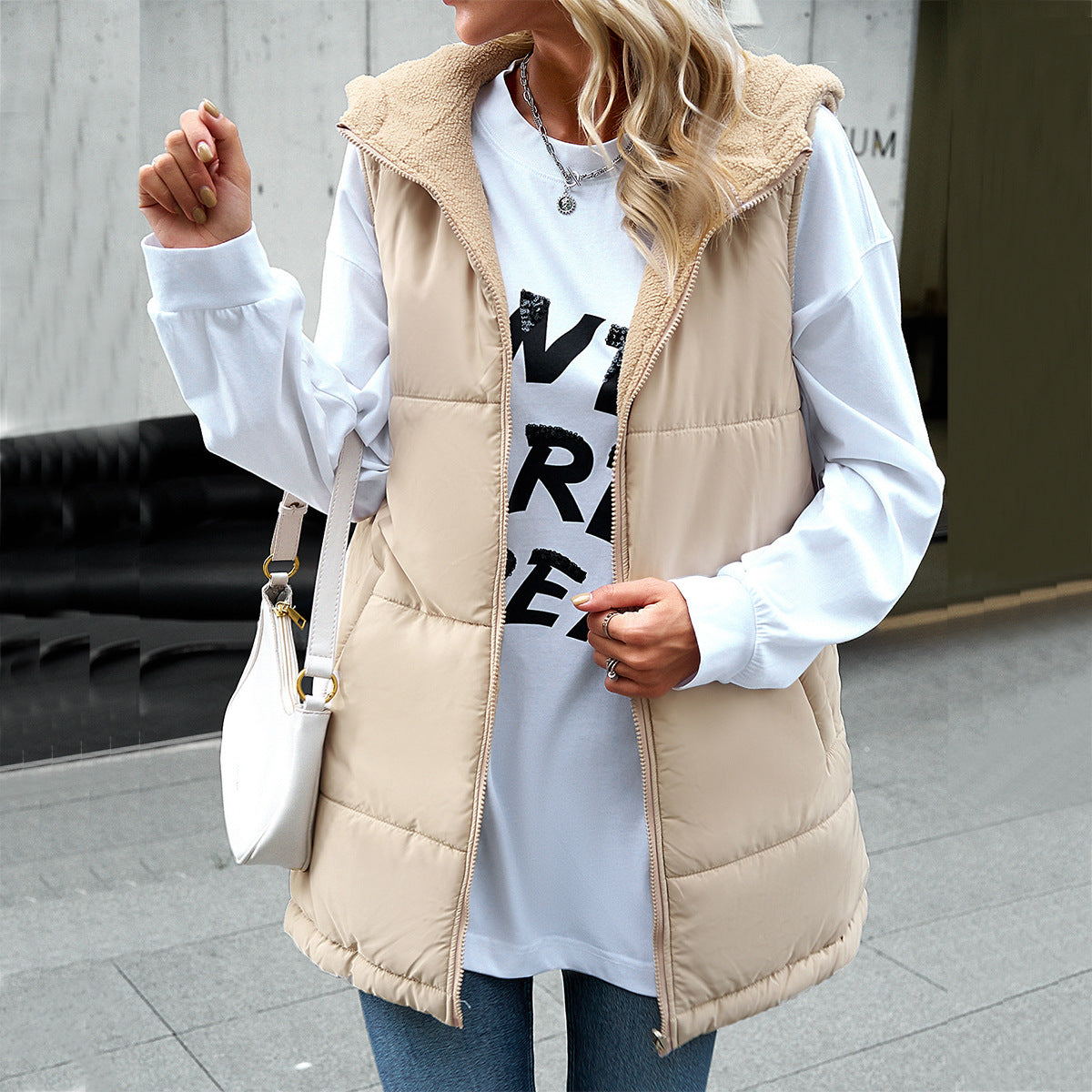 Women's mid-length hooded winter vest with zipper, pockets, and fluffy cotton padding in a loose fit