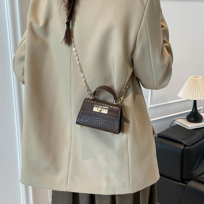 Casual small square handbag with shoulder strap, compact structured design in a neutral color