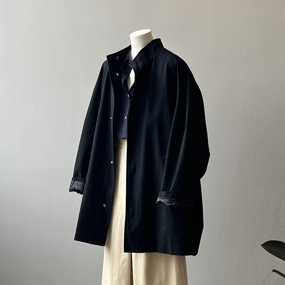 Japanese style women's workwear trench coat with stand collar, long sleeves, and structured silhouette