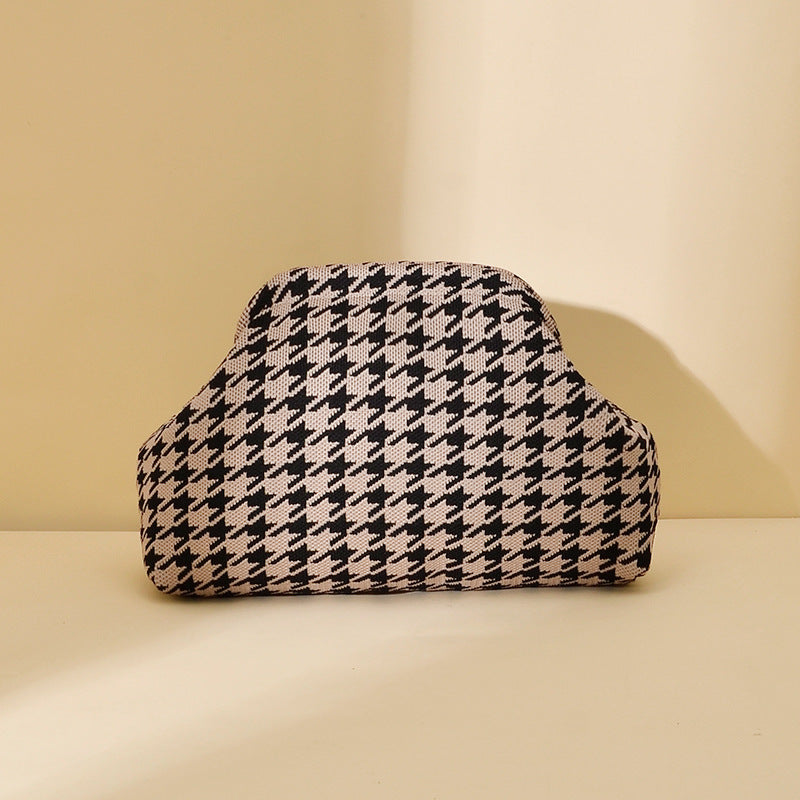 Women's knitted striped clutch bag with textured woven design and compact rectangular shape