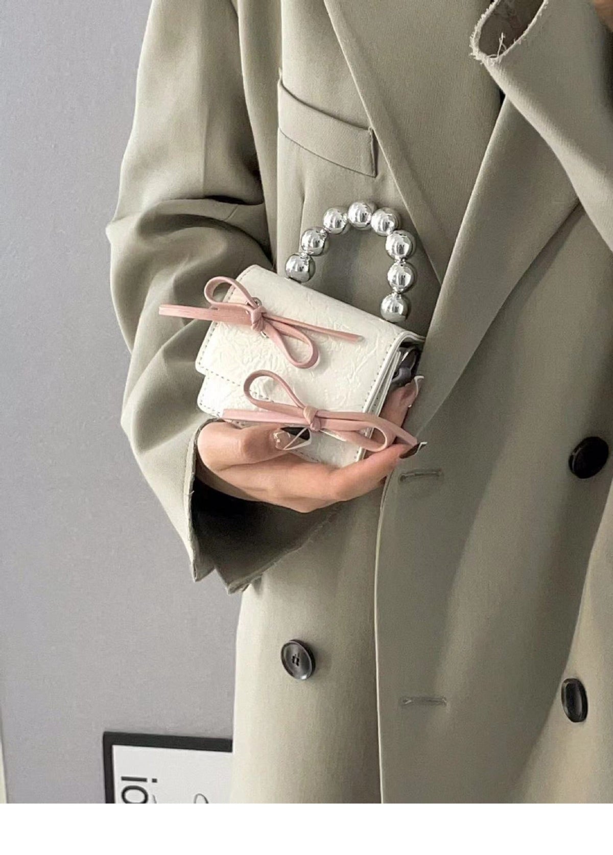 Textured cute bow mini chain handbag with a decorative bow and chain strap