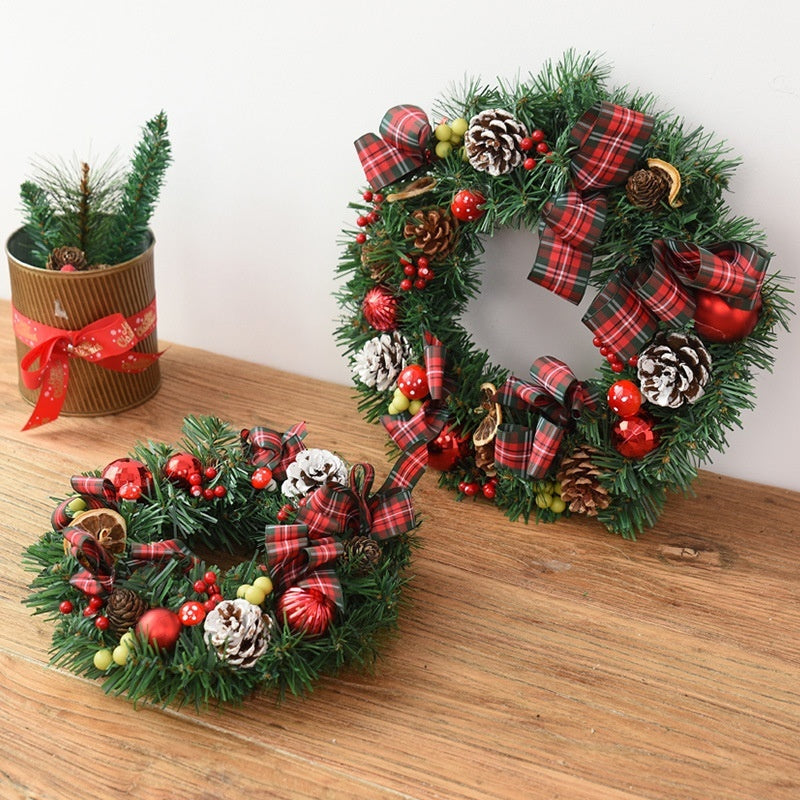Christmas garland bow door hanging with festive red and green Christmas decorations for window or door display