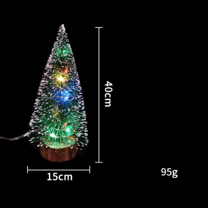 Mini Christmas tree with LED lights, festive Christmas decoration displayed on a white background