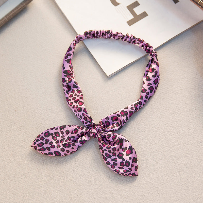 Big bow tie bunny ears headband with oversized bow and playful rabbit ear design