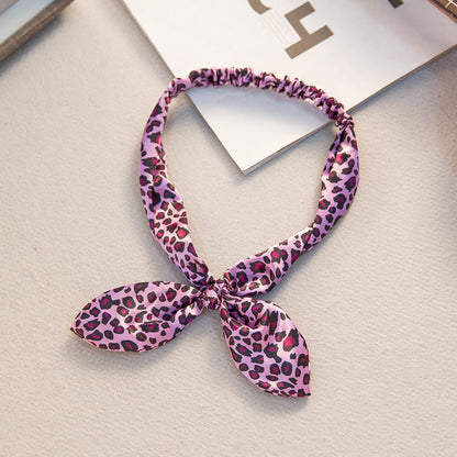 Big bow tie bunny ears headband with oversized bow and playful rabbit ear design