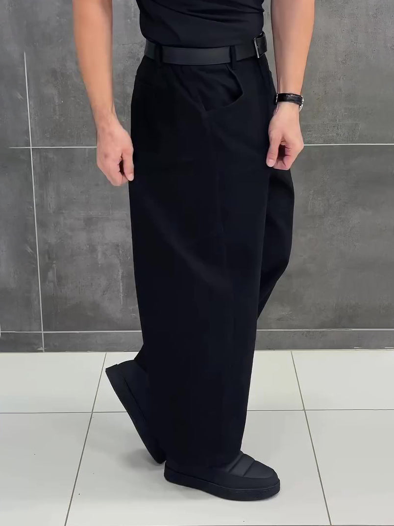 Black 3D tailored wide-leg cropped pants with structured pleats and a relaxed silhouette