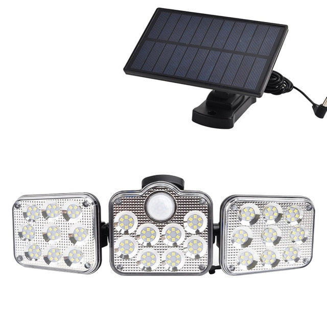 Solar wall light mounted on an exterior wall, featuring a compact design and integrated solar panel